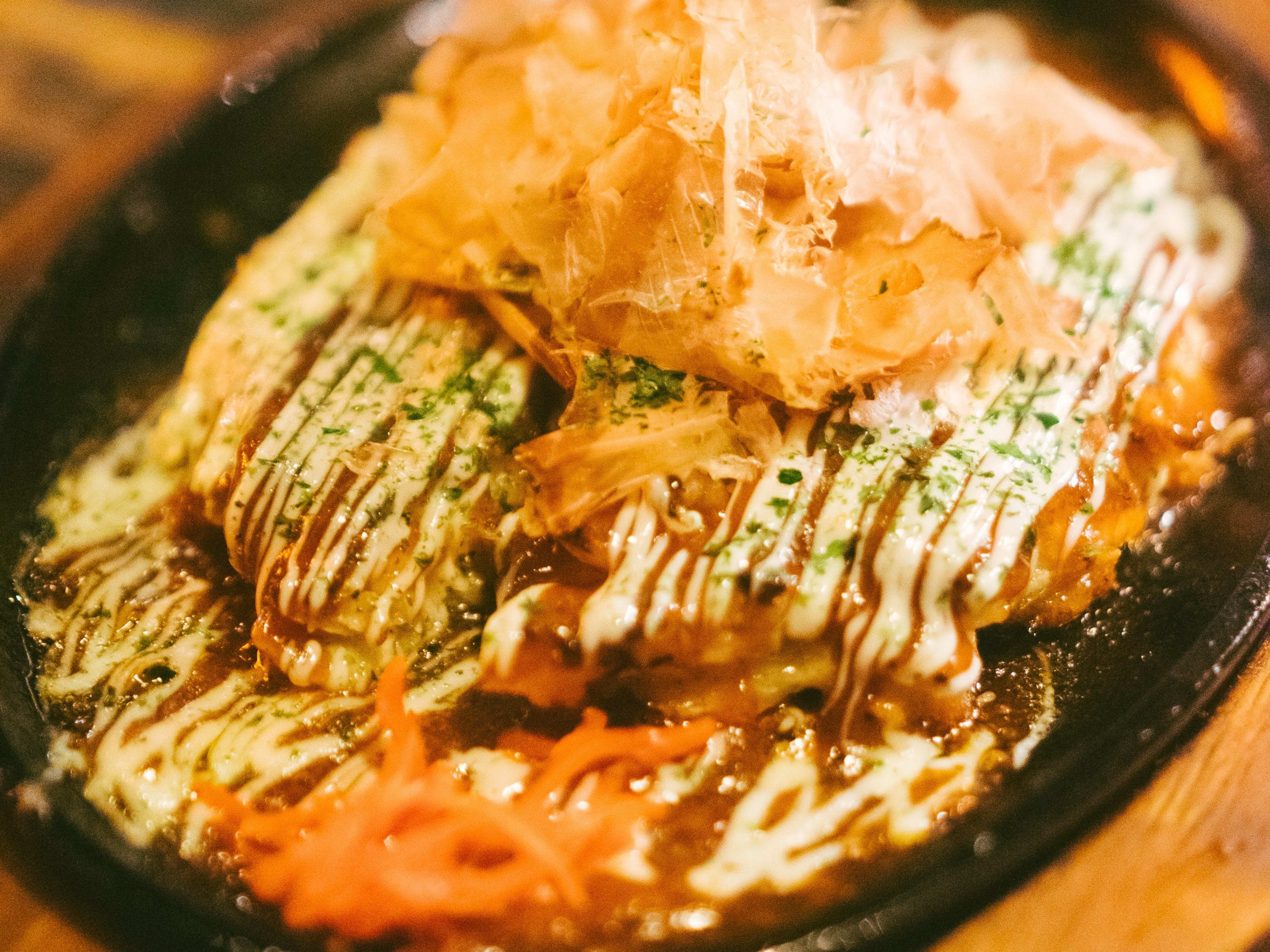 Okonomiyaki savory pancake topped with bonito flakes